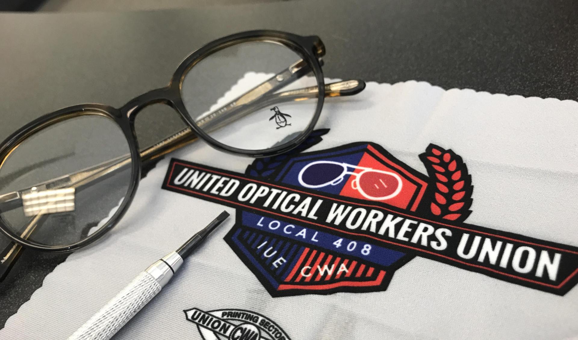 Spectacles on a table with a logo printed on cloth