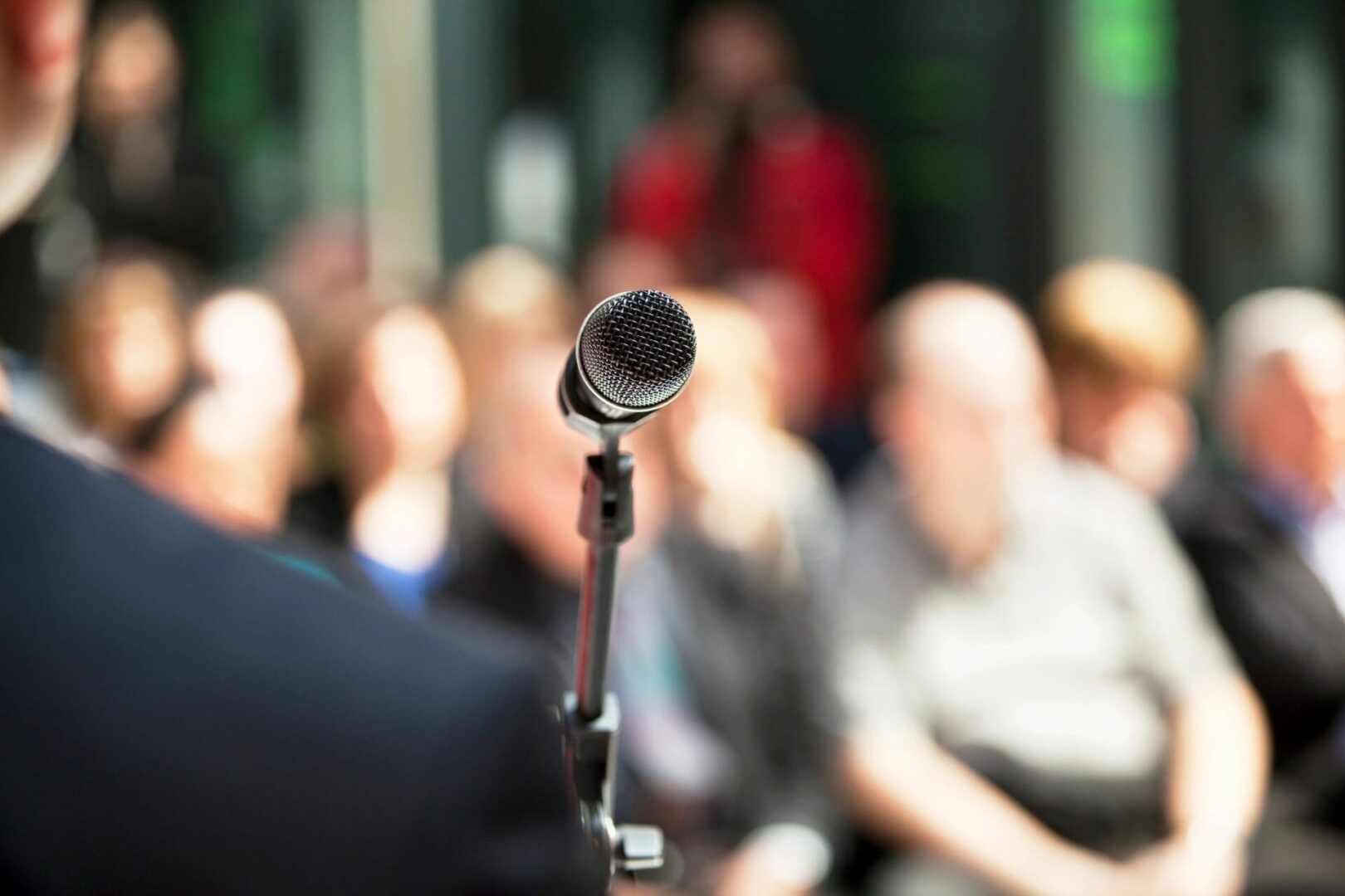 public speaker and microphone with audience